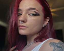 She has several piercings in her ears and nose including her side nose and nasal septum.